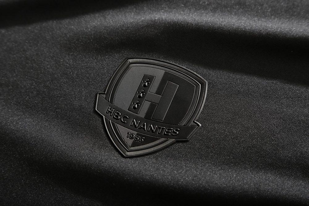 Image showing a black HBC Nantes badge in textured TPU
