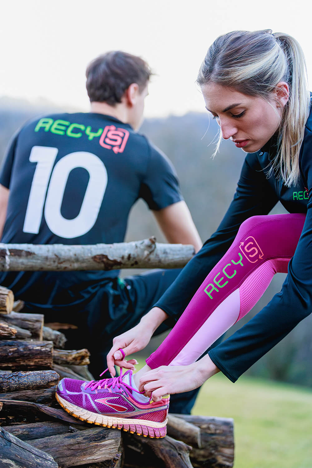 Image showing two models wearing RECYS branded sports gear