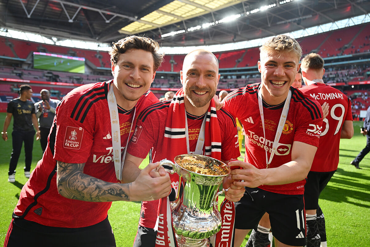 Image showing Man Utd players celebrating an FA Cup win holding the trophy with FA Cup badges on their sleeve