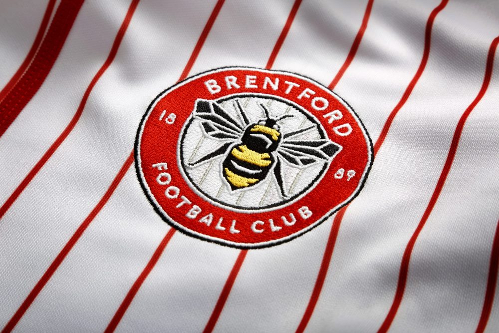 Image showing a closeup of an embroidered Brentford FC badge, manufactured by ID UNLIMITED