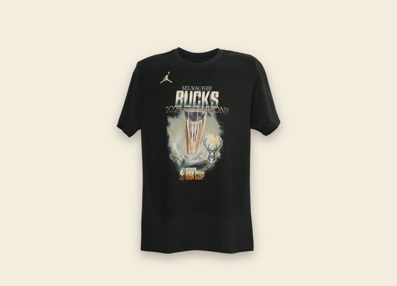 Image showing a Milwaukee bucks t shirt apparel manufactured by ID UNLIMITED, posed on a cream background